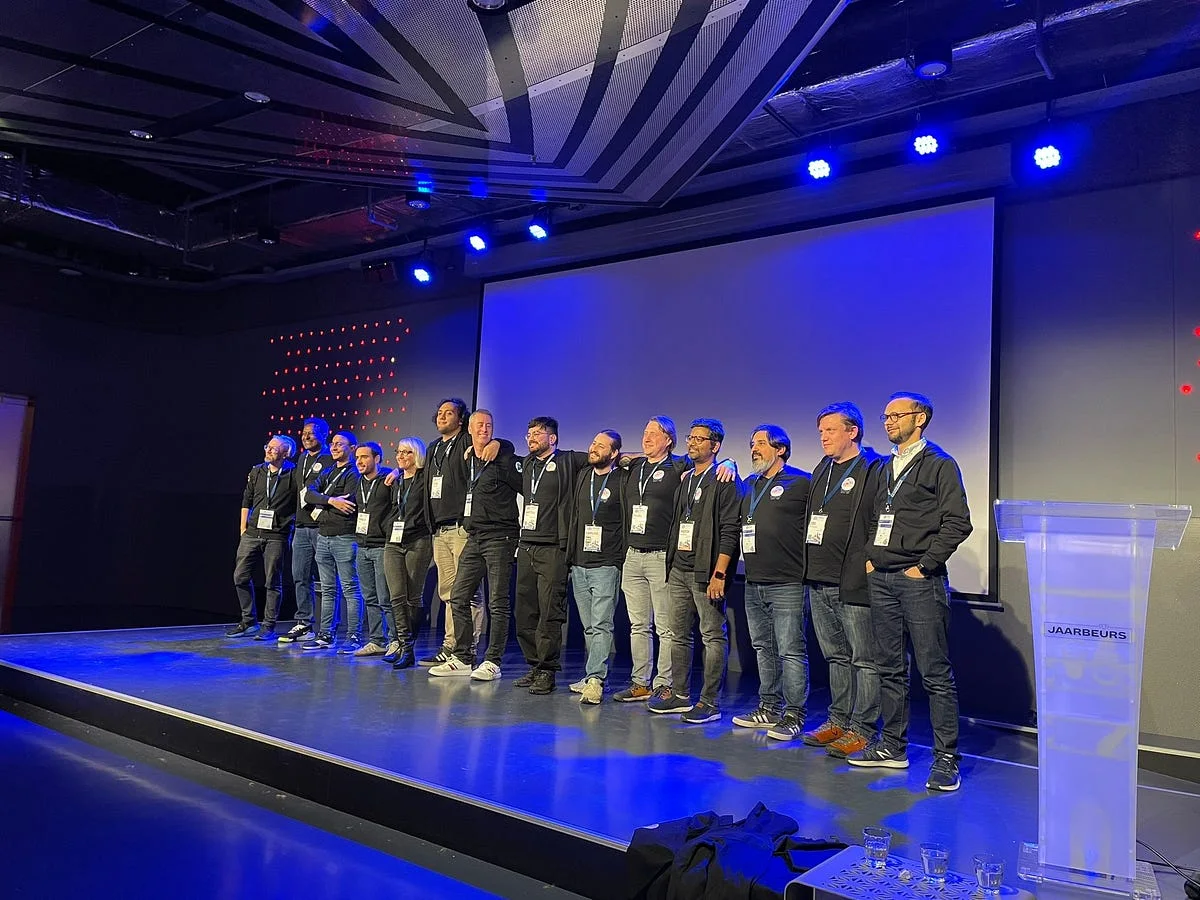 Kubernetes Community Days organizers standing together on stage